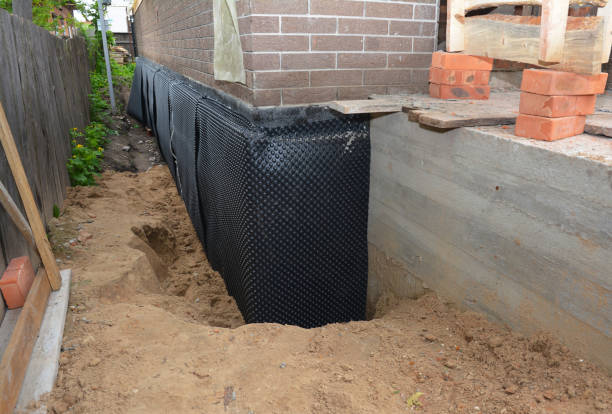 Happy homeowners after waterproofing job in Monon